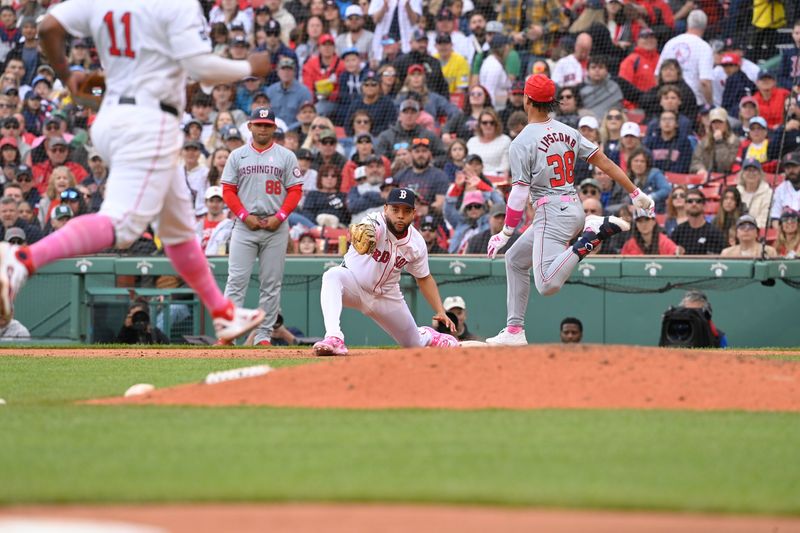 May 12, 2024; Boston, Massachusetts, USA;  Boston Red Sox first baseman Dominic Smith (2) makes a catch for an out against Washington Nationals third baseman Trey Lipscomb (38) during the ninth inning at Fenway Park. Mandatory Credit: Eric Canha-USA TODAY Sports