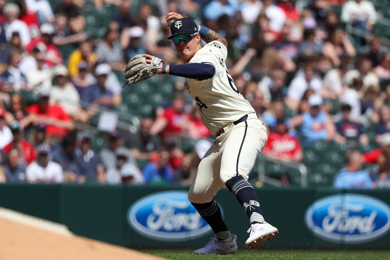 Apr 25, 2024; Minneapolis, Minnesota, USA; Minnesota Twins third baseman Jose Miranda (64) throws the ball to first base to get out Chicago White Sox center fielder Kevin Pillar (12) during the sixth inning at Target Field. Mandatory Credit: Matt Krohn-USA TODAY Sports