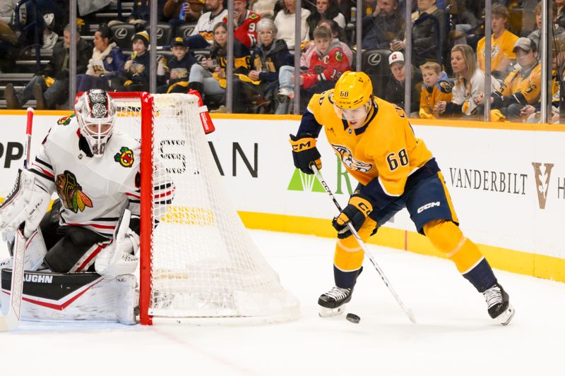 Jan 16, 2025; Nashville, Tennessee, USA;  Chicago Blackhawks goaltender Arvid Soderblom (40) blocks the shot of Nashville Predators left wing Zachary L'Heureux (68) during the first period at Bridgestone Arena. Mandatory Credit: Steve Roberts-Imagn Images