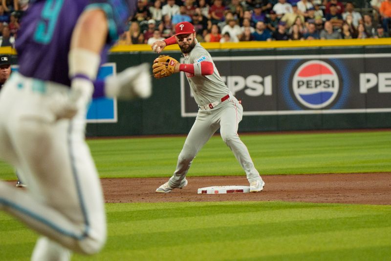 Sep 19, 2025; Phoenix, Arizona, USA;  Philadelphia Phillies outfielder Weston Wilson (37) throws to first base ahead of Arizona Diamondbacks infielder Blaze Alexander (9) in the second inning at Chase Field. Mandatory Credit: Allan Henry-Imagn Images