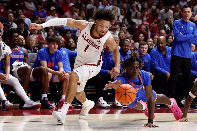 Feb 21, 2024; Tuscaloosa, Alabama, USA; Florida Gators guard Denzel Aberdeen (11) and Alabama Crimson Tide guard Mark Sears (1) reach for a loose ball during the first half at Coleman Coliseum. Mandatory Credit: Butch Dill-USA TODAY Sports