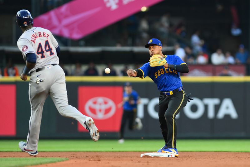 Jul 19, 2024; Seattle, Washington, USA; Seattle Mariners second baseman Jorge Polanco (7) throws the ball to first base to complete a double play against the Houston Astros during the fifth inning at T-Mobile Park. Mandatory Credit: Steven Bisig-USA TODAY Sports