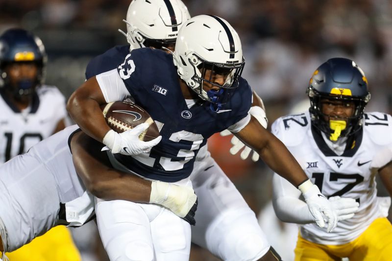 Sep 2, 2023; University Park, Pennsylvania, USA; Penn State Nittany Lions running back Kaytron Allen (13) runs the ball against the West Virginia Mountaineers during the first quarter at Beaver Stadium. Mandatory Credit: Matthew O'Haren-USA TODAY Sports