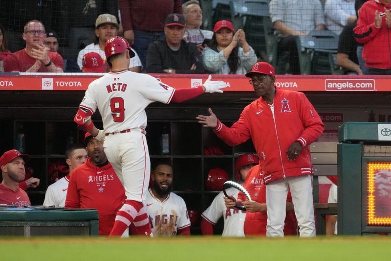 Apr 30, 2024; Anaheim, California, USA; Los Angeles Angels shortstop Zach Neto (9) is congratulated by manager Ron Washington after hitting a home run in the third inning against the Philadelphia Phillies at Angel Stadium. Mandatory Credit: Kirby Lee-USA TODAY Sports