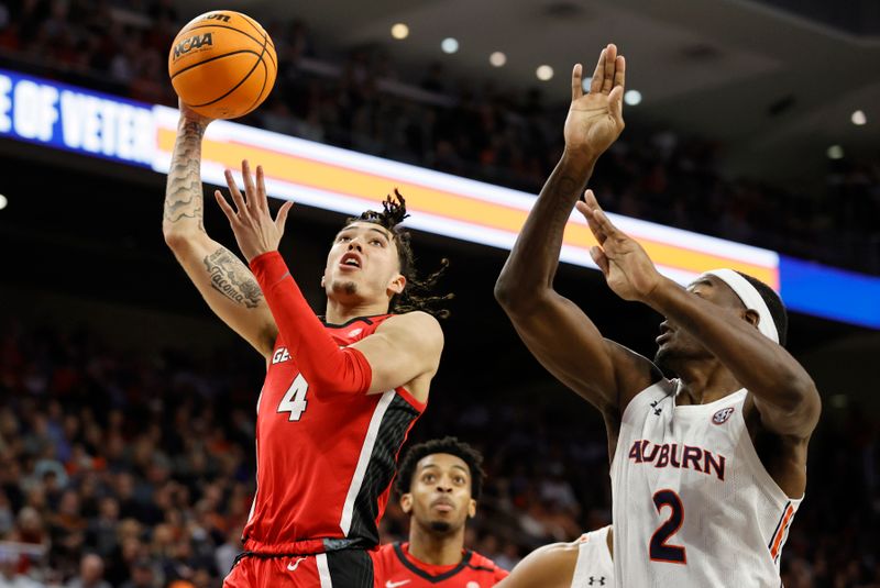 Feb 1, 2023; Auburn, Alabama, USA;  Georgia Bulldogs guard Jusaun Holt (4) gets around  Auburn Tigers forward Jaylin Williams (2) for a shot during the first half at Neville Arena. Mandatory Credit: John Reed-USA TODAY Sports