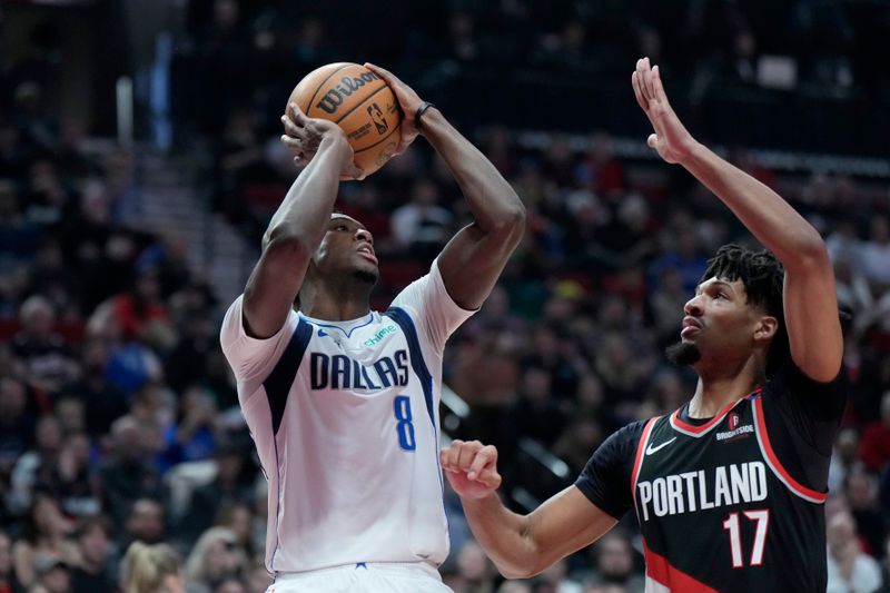 PORTLAND, OREGON - DECEMBER 01: Olivier-Maxence Prosper #8 of the Dallas Mavericks shoots the ball over Shaedon Sharpe #17 of the Portland Trail Blazers during the first half at Moda Center on December 01, 2024 in Portland, Oregon. NOTE TO USER: User expressly acknowledges and agrees that, by downloading and or using this photograph, User is consenting to the terms and conditions of the Getty Images License Agreement. (Photo by Soobum Im/Getty Images)