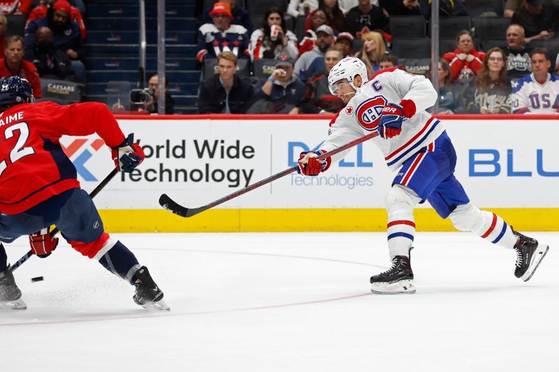 Oct 31, 2024; Washington, District of Columbia, USA; Montreal Canadiens center Nick Suzuki (14) scores a goal against the Washington Capitals in the second period at Capital One Arena. Mandatory Credit: Geoff Burke-Imagn Images