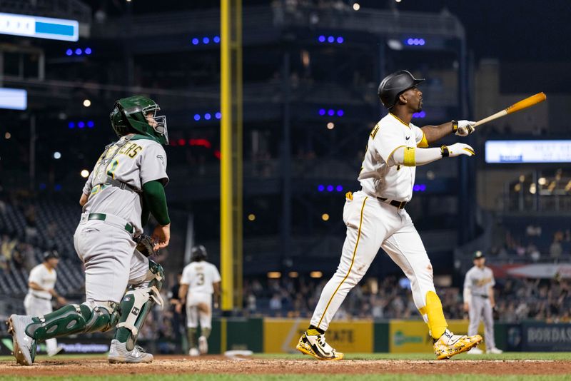 Jun 5, 2023; Pittsburgh, Pennsylvania, USA;  Pittsburgh Pirates designated hitter Andrew McCutchen (22) and Oakland Athletics catcher Shea Langeliers (23) watch the ball on a sacrifice fly that scores the winning run during the eighth inning against the Oakland Athletics at PNC Park. Mandatory Credit: Scott Galvin-USA TODAY Sports