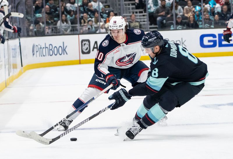 Jan 28, 2024; Seattle, Washington, USA; Seattle Kraken defenseman Brian Dumoulin (8) skates against Columbus Blue Jackets forward Dmitri Voronkov (10) during the first period at Climate Pledge Arena. Mandatory Credit: Stephen Brashear-USA TODAY Sports