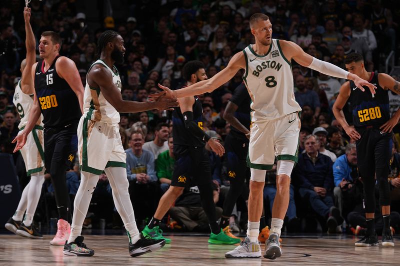 DENVER, CO - MARCH 7: Kristaps Porzingis #8 high fives Jaylen Brown #7 of the Boston Celtics during the game against the Denver Nuggets on March 7, 2024 at the Ball Arena in Denver, Colorado. NOTE TO USER: User expressly acknowledges and agrees that, by downloading and/or using this Photograph, user is consenting to the terms and conditions of the Getty Images License Agreement. Mandatory Copyright Notice: Copyright 2024 NBAE (Photo by Bart Young/NBAE via Getty Images)