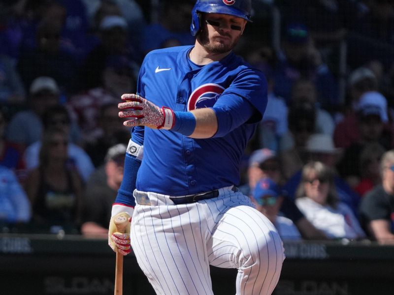 Mar 4, 2025; Mesa, Arizona, USA; Chicago Cubs outfielder Ian Happ (8) reacts after missing a pitch against the San Diego Padres in the first inning at Sloan Park. Mandatory Credit: Rick Scuteri-Imagn Images