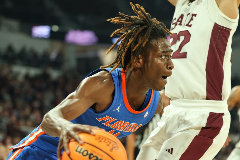 Feb 11, 2025; Starkville, Mississippi, USA; Florida Gators guard Denzel Aberdeen (11) drives to the basket against the Mississippi State Bulldogs during the first half at Humphrey Coliseum. Mandatory Credit: Wesley Hale-Imagn Images