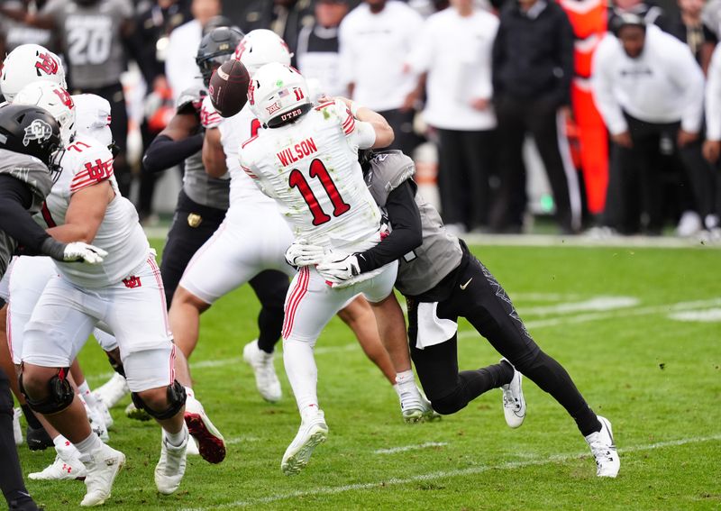 Nov 16, 2024; Boulder, Colorado, USA; Colorado Buffaloes safety Shilo Sanders (21) forces a fumble after a sack on Utah Utes quarterback Isaac Wilson (11) in the fourth quarter at Folsom Field. Mandatory Credit: Ron Chenoy-Imagn Images