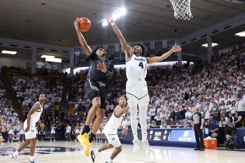 Jan 30, 2024; Logan, Utah, USA; San Jose State Spartans guard Myron Amey Jr. (0) goes to the basket against Utah State Aggies guard Ian Martinez (4) during the first half at Dee Glen Smith Spectrum. Mandatory Credit: Rob Gray-USA TODAY Sports