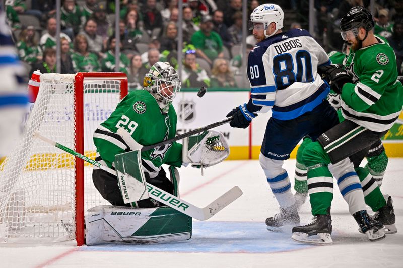 Oct 17, 2022; Dallas, Texas, USA; Dallas Stars goaltender Jake Oettinger (29) looks for the puck as defenseman Jani Hakanpaa (2) defends against Winnipeg Jets left wing Pierre-Luc Dubois (80) during the third period at the American Airlines Center. Mandatory Credit: Jerome Miron-USA TODAY Sports