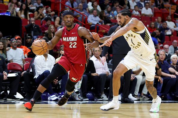 MIAMI, FLORIDA - NOVEMBER 30: Jimmy Butler #22 of the Miami Heat drives against Obi Toppin #1 of the Indiana Pacers during the first quarter of the game at Kaseya Center on November 30, 2023 in Miami, Florida. NOTE TO USER: User expressly acknowledges and agrees that, by downloading and or using this photograph, User is consenting to the terms and conditions of the Getty Images License Agreement. (Photo by Megan Briggs/Getty Images)