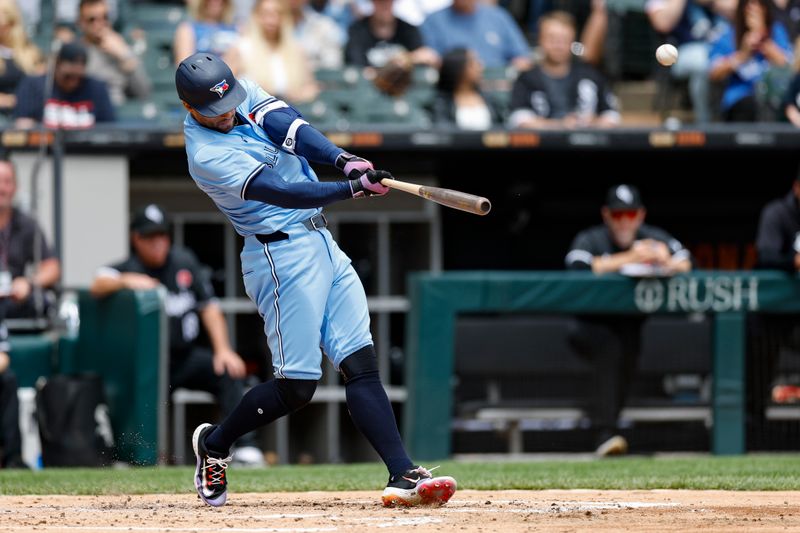 May 27, 2024; Chicago, Illinois, USA; Toronto Blue Jays outfielder George Springer (4) hits a two-run home run against the Chicago White Sox during the second inning at Guaranteed Rate Field. Mandatory Credit: Kamil Krzaczynski-USA TODAY Sports