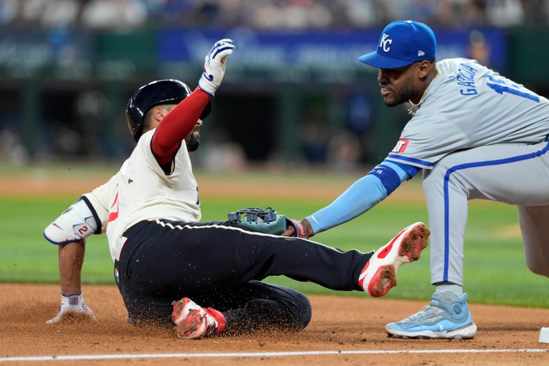 Jun 21, 2024; Arlington, Texas, USA; Texas Rangers second baseman Marcus Semien (2) is tagged out attempting to stretch a double into a triple by Kansas City Royals third baseman Maikel Garcia (11) during the sixth inning at Globe Life Field. Mandatory Credit: Jim Cowsert-USA TODAY Sports