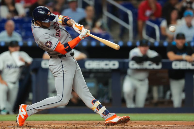Aug 4, 2025; Miami, Florida, USA; Houston Astros shortstop Jeremy Pena (3) hits a double against the Miami Marlins during the fourth inning at loanDepot Park. Mandatory Credit: Sam Navarro-Imagn Images