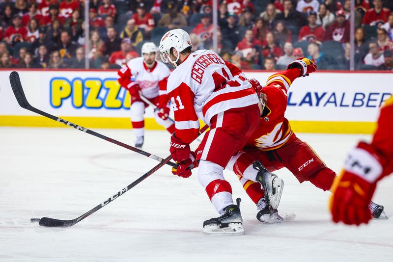 Feb 17, 2024; Calgary, Alberta, CAN; Calgary Flames center Connor Zary (47) trips Detroit Red Wings defenseman Shayne Gostisbehere (41) during the third period at Scotiabank Saddledome. Mandatory Credit: Sergei Belski-USA TODAY Sports