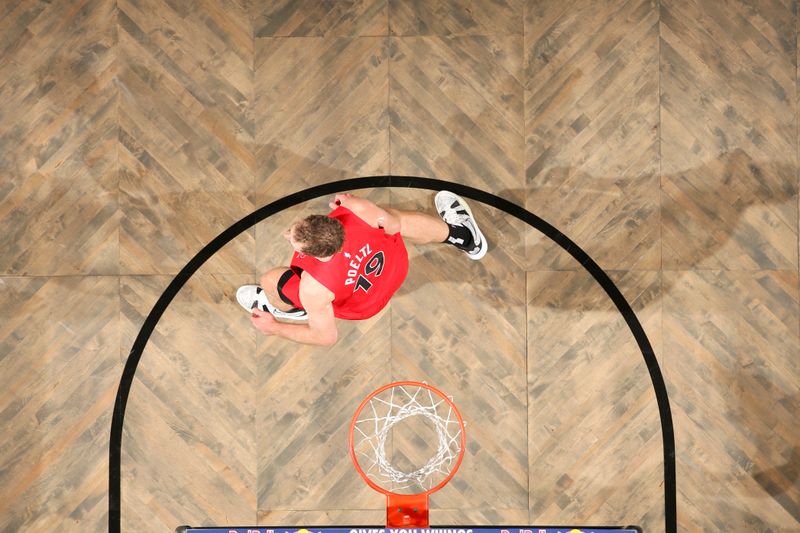 BROOKLYN, NY - OCTOBER 18: Jakob Poeltl #19 of the Toronto Raptors looks on during the game on October 18, 2024 at Barclays Center in Brooklyn, New York. NOTE TO USER: User expressly acknowledges and agrees that, by downloading and or using this Photograph, user is consenting to the terms and conditions of the Getty Images License Agreement. Mandatory Copyright Notice: Copyright 2024 NBAE (Photo by Nathaniel S. Butler/NBAE via Getty Images)