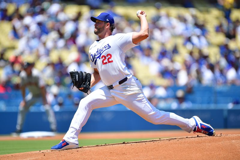 Jul 25, 2024; Los Angeles, California, USA; Los Angeles Dodgers starting pitcher Clayton Kershaw (22) throws against the San Francisco Giants during the first inning at Dodger Stadium. Mandatory Credit: Gary A. Vasquez-USA TODAY Sports