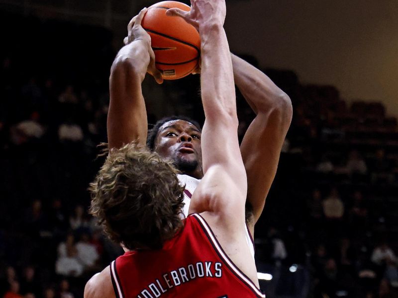 Jan 15, 2025; Blacksburg, Virginia, USA; Virginia Tech Hokies forward Mylyjael Poteat (34) shoots the ball against North Carolina State Wolfpack forward Ben Middlebrooks (34) during the first half at Cassell Coliseum. Mandatory Credit: Peter Casey-Imagn Images