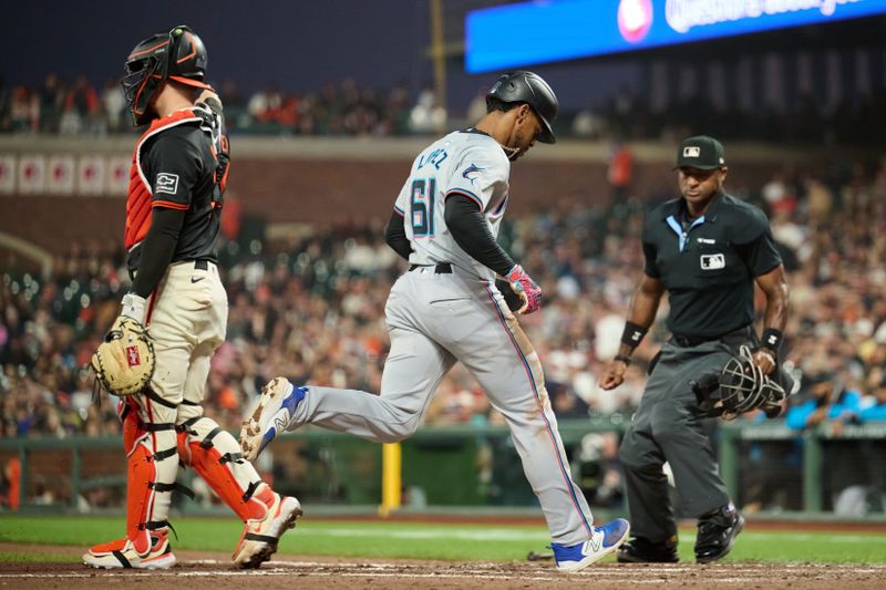 Aug 31, 2024; San Francisco, California, USA; home plate umpire Alan Porter (64) watches Miami Marlins infielder Otto Lopez (61) score a run against the San Francisco Giants during the seventh inning at Oracle Park. Mandatory Credit: Robert Edwards-USA TODAY Sports