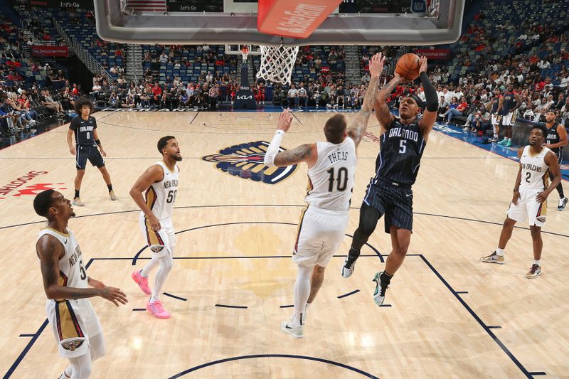 NEW ORLEANS, LA - OCTOBER 7: Paolo Banchero #5 of the Orlando Magic drives to the basket during the game against the New Orleans Pelicans on October 7, 2024 at the Smoothie King Center in New Orleans, Louisiana. NOTE TO USER: User expressly acknowledges and agrees that, by downloading and or using this Photograph, user is consenting to the terms and conditions of the Getty Images License Agreement. Mandatory Copyright Notice: Copyright 2024 NBAE (Photo by Layne Murdoch Jr./NBAE via Getty Images)