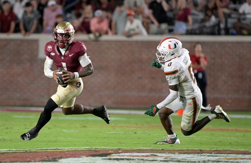 Oct 4, 2025; Tallahassee, Florida, USA; Florida State Seminoles quarterback Tommy Castellanos (1) scrambles from Miami Hurricanes defensive back Keionte Scott during the second half at Doak S. Campbell Stadium. Mandatory Credit: Melina Myers-Imagn Images