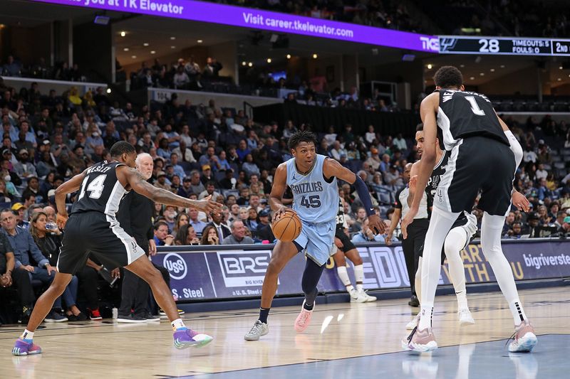 MEMPHIS, TENNESSEE - APRIL 09: GG Jackson #45 of the Memphis Grizzlies handles the ball against Blake Wesley #14 and Victor Wembanyama #1 of the San Antonio Spurs during the first half at FedExForum on April 09, 2024 in Memphis, Tennessee. NOTE TO USER: User expressly acknowledges and agrees that, by downloading and or using this photograph, User is consenting to the terms and conditions of the Getty Images License Agreement. (Photo by Justin Ford/Getty Images)