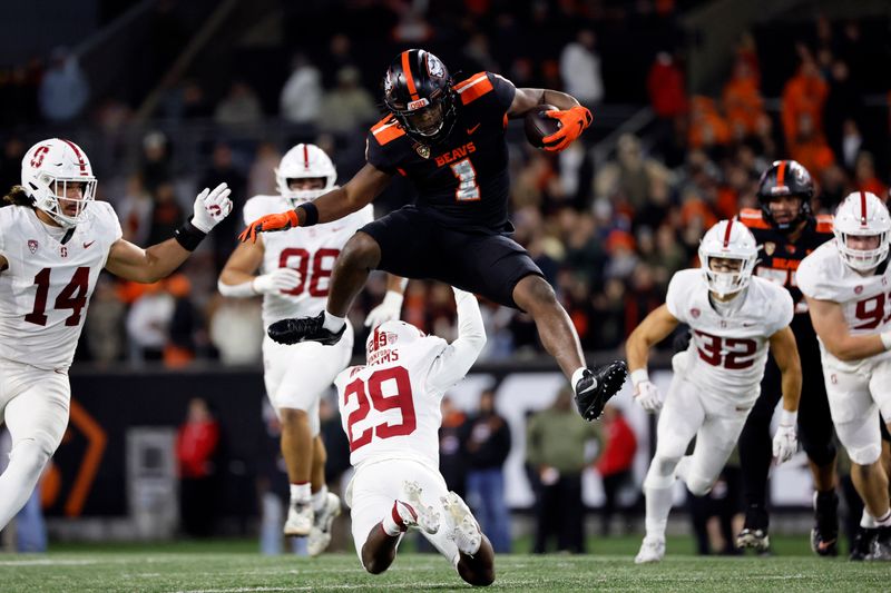 Nov 11, 2023; Corvallis, Oregon, USA; Oregon State Beavers running back Deshaun Fenwick (1) jumps over Stanford Cardinal corner back Terian Williams (29) during the second half at Reser Stadium. Mandatory Credit: Soobum Im-USA TODAY Sports