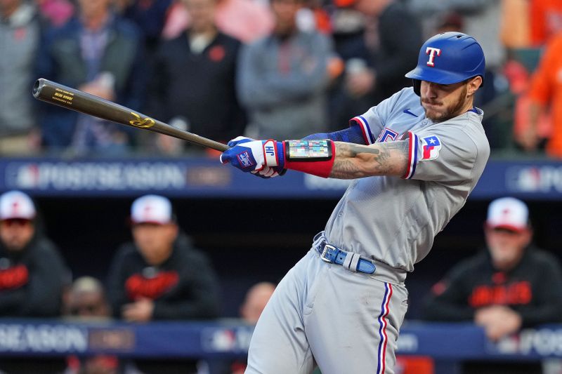 Oct 8, 2023; Baltimore, Maryland, USA; Texas Rangers catcher Jonah Heim (28) hits an RBI single during the second inning against the Baltimore Orioles during game two of the ALDS for the 2023 MLB playoffs at Oriole Park at Camden Yards. Mandatory Credit: Mitch Stringer-USA TODAY Sports