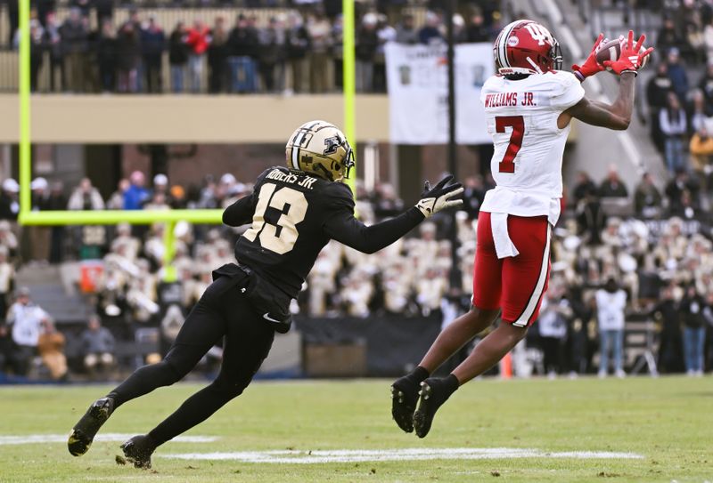 Nov 25, 2023; West Lafayette, Indiana, USA;  Indiana Hoosiers wide receiver E.J. Williams Jr. (7) catches a pass in front of Purdue Boilermakers defensive back Derrick Rogers Jr. (13) during the second half at Ross-Ade Stadium. Mandatory Credit: Robert Goddin-USA TODAY Sports