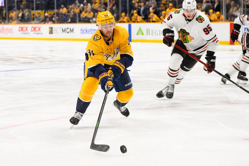 Jan 16, 2025; Nashville, Tennessee, USA;  Nashville Predators center Jonathan Marchessault (81) skates with the puck against the Chicago Blackhawks during the third period at Bridgestone Arena. Mandatory Credit: Steve Roberts-Imagn Images