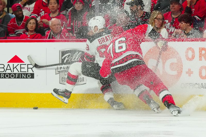 May 11, 2023; Raleigh, North Carolina, USA; New Jersey Devils left wing Jesper Bratt (63) controls the puck against Carolina Hurricanes defenseman Brady Skjei (76) during the second period in game five of the second round of the 2023 Stanley Cup Playoffs at PNC Arena. Mandatory Credit: James Guillory-USA TODAY Sports