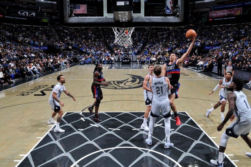 ORLANDO, FL - NOVEMBER 23: Simone Fontecchio #19 of the Detroit Pistons drives to the basket during the game against the Orlando Magic on November 23, 2024 at Kia Center in Orlando, Florida. NOTE TO USER: User expressly acknowledges and agrees that, by downloading and or using this photograph, User is consenting to the terms and conditions of the Getty Images License Agreement. Mandatory Copyright Notice: Copyright 2024 NBAE (Photo by Fernando Medina/NBAE via Getty Images)