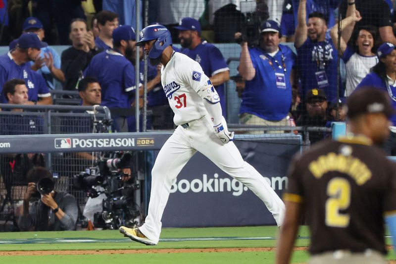 Oct 11, 2024; Los Angeles, California, USA; Los Angeles Dodgers outfielder Teoscar Hernandez (37) runs after hitting a solo home run in the seventh inning against the San Diego Padres during game five of the NLDS for the 2024 MLB Playoffs at Dodger Stadium. Mandatory Credit: Kiyoshi Mio-Imagn Images