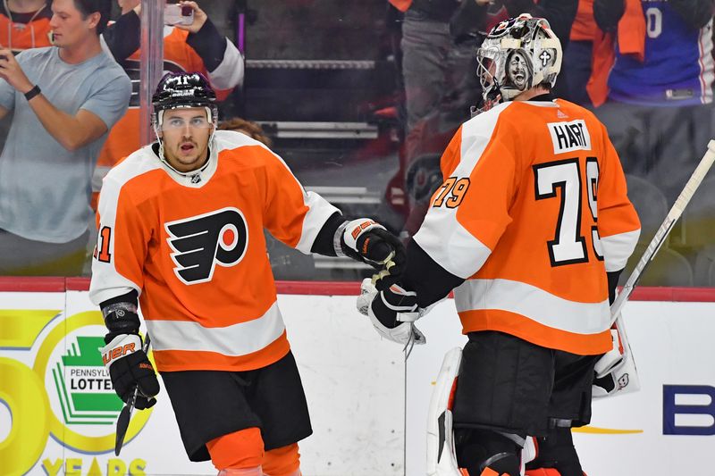 Oct 13, 2022; Philadelphia, Pennsylvania, USA; Philadelphia Flyers right wing Travis Konecny (11) celebrates his goal with Philadelphia Flyers goaltender Carter Hart (79) during the third period at Wells Fargo Center. Mandatory Credit: Eric Hartline-USA TODAY Sports