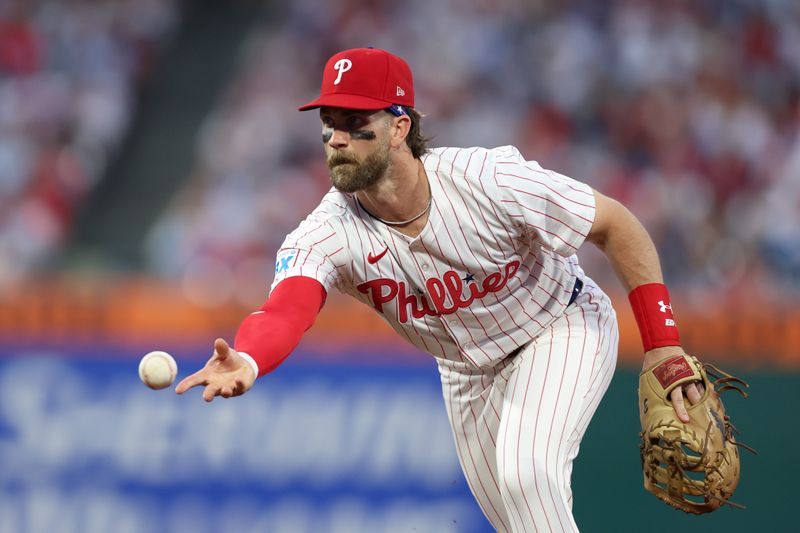 May 3, 2025; Philadelphia, Pennsylvania, USA; Philadelphia Phillies first base Bryce Harper (3) tosses to first base for an out against the Arizona Diamondbacks during the fifth inning at Citizens Bank Park. Mandatory Credit: Bill Streicher-Imagn Images