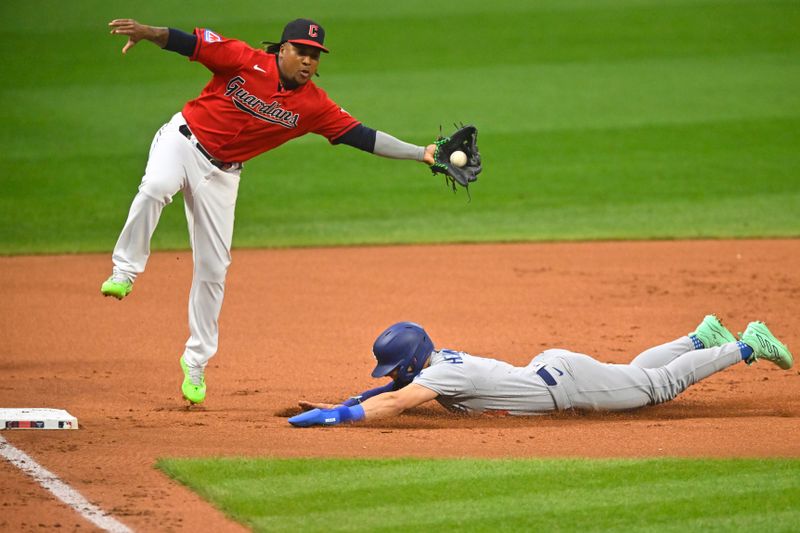 Aug 23, 2023; Cleveland, Ohio, USA; Cleveland Guardians third baseman Jose Ramirez (11) catches the ball as Los Angeles Dodgers third baseman Enrique Hernandez (8) advances to third base on a wild pitch in the first inning Progressive Field. Mandatory Credit: David Richard-USA TODAY Sports