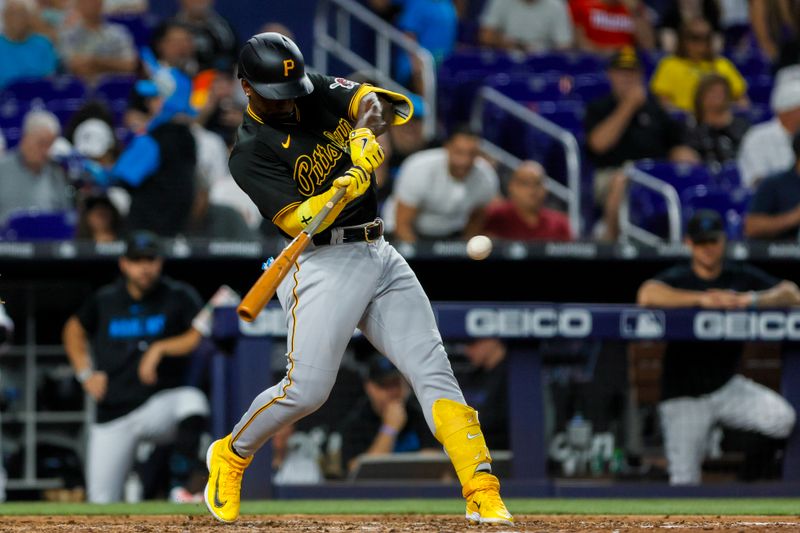 Jun 25, 2023; Miami, Florida, USA; Pittsburgh Pirates designated hitter Andrew McCutchen (22) hits a single against the Miami Marlins during the eighth inning at loanDepot Park. Mandatory Credit: Sam Navarro-USA TODAY Sports