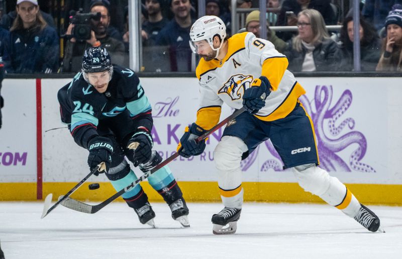 Nov 20, 2024; Seattle, Washington, USA;  Nashville Predators forward Filip Forsberg (9) skates against Seattle Kraken defenseman Jamie Oleksiak (24) during the second period at Climate Pledge Arena. Mandatory Credit: Stephen Brashear-Imagn Images