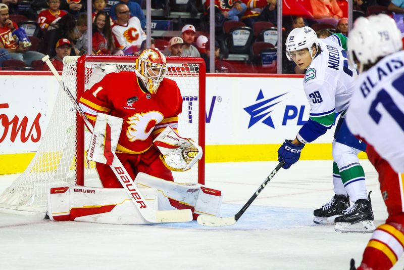 Sep 28, 2024; Calgary, Alberta, CAN; Calgary Flames goaltender Devin Cooley (1) makes a save against the Vancouver Canucks during the third period at Scotiabank Saddledome. Mandatory Credit: Sergei Belski-Imagn Images