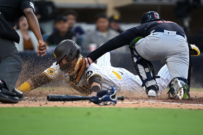 Jun 15, 2023; San Diego, California, USA; San Diego Padres designated hitter Nelson Cruz (32) is tagged out at home by Cleveland Guardians catcher David Fry (12) during the fifth inning at Petco Park. Mandatory Credit: Orlando Ramirez-USA TODAY Sports