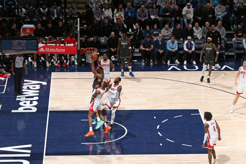 MINNEAPOLIS, MN -  APRIL 2:  Rudy Gobert #27 of the Minnesota Timberwolves grabs a rebound during the game against the Houston Rockets on April 2, 2024 at Target Center in Minneapolis, Minnesota. NOTE TO USER: User expressly acknowledges and agrees that, by downloading and or using this Photograph, user is consenting to the terms and conditions of the Getty Images License Agreement. Mandatory Copyright Notice: Copyright 2024 NBAE (Photo by David Sherman/NBAE via Getty Images)