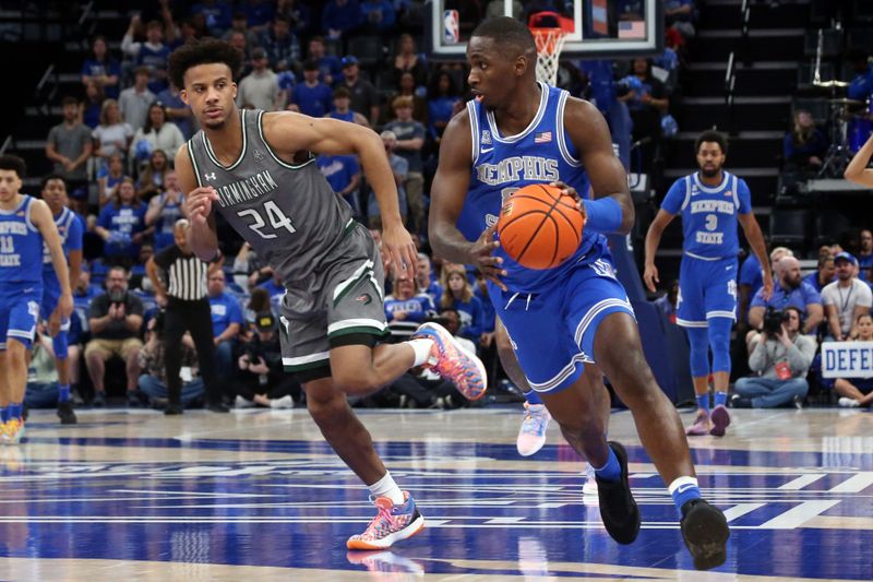 Mar 3, 2024; Memphis, Tennessee, USA; Memphis Tigers forward David Jones (8) dribbles up the court as UAB Blazers guard Efrem Johnson (24) defends during the first half at FedExForum. Mandatory Credit: Petre Thomas-USA TODAY Sports