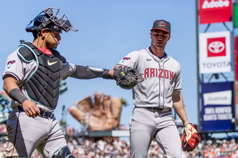 Apr 21, 2024; San Francisco, California, USA;  Arizona Diamondbacks pitcher Bryce Jarvis (40) and catcher Gabriel Moreno (14) fist-bump after ending the inning with the bases loaded during the seventh inning of the game against the San Francisco Giants at Oracle Park. Mandatory Credit: John Hefti-USA TODAY Sports