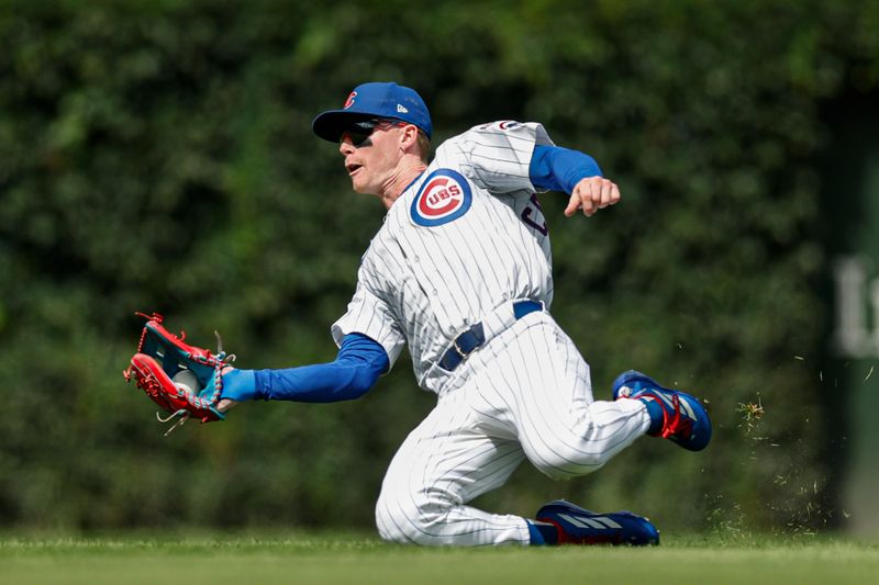Aug 21, 2025; Chicago, Illinois, USA; Chicago Cubs center fielder Pete Crow-Armstrong (4) catches a fly ball hit by Milwaukee Brewers first baseman Andrew Vaughn during the fourth inning at Wrigley Field. Mandatory Credit: Kamil Krzaczynski-Imagn Images