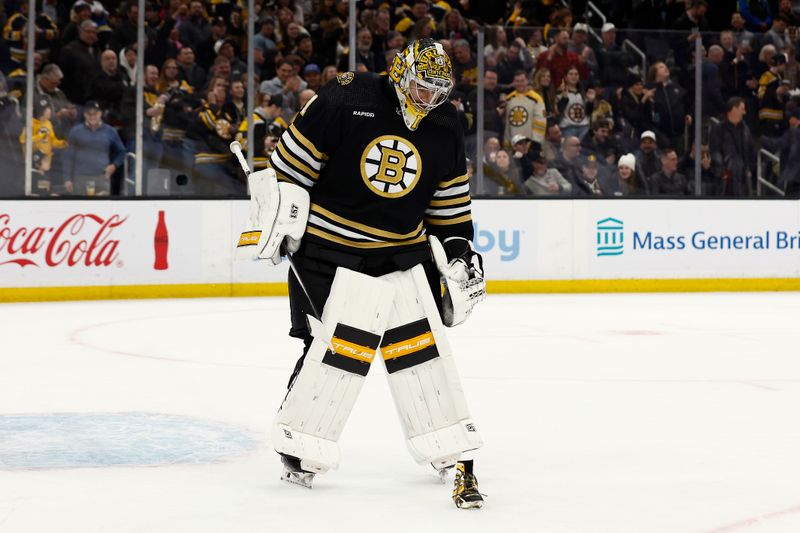 Feb 29, 2024; Boston, Massachusetts, USA; Boston Bruins goaltender Jeremy Swayman (1) moves to pick up a shoe that was thrown on the ice after center Morgan Geekie (39) scored his third goal of the game against the Vegas Golden Knights during the seond period at TD Garden. Mandatory Credit: Winslow Townson-USA TODAY Sports